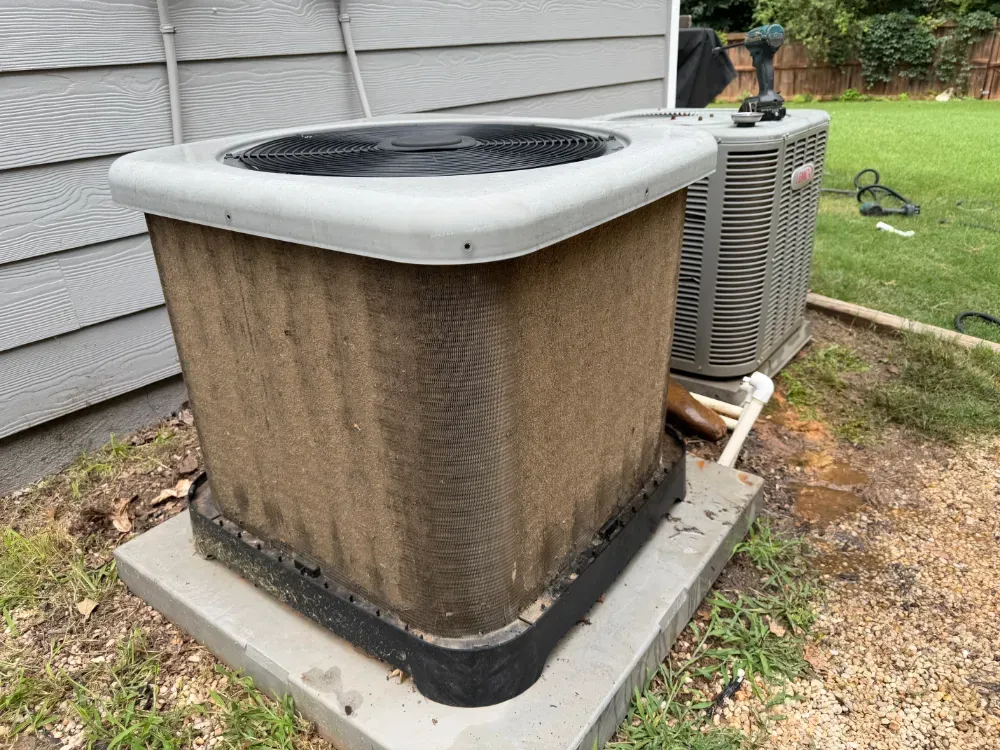 An aging condenser cabinet standing beside a Lennox unit at a Fountain Inn home