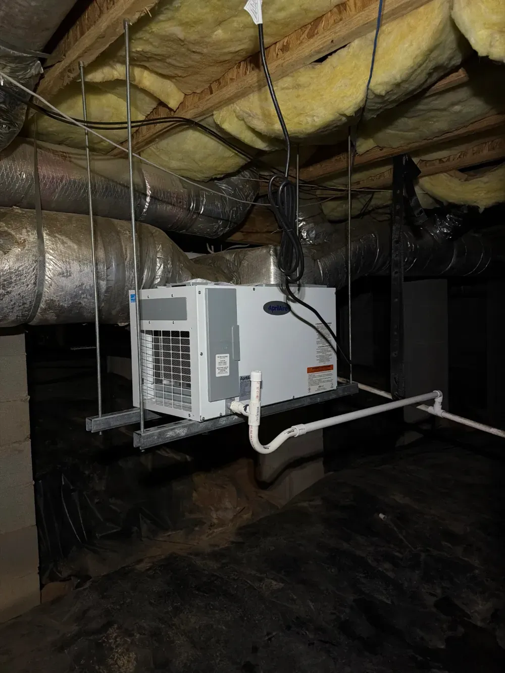 An AprilAire dehumidifier installed in a Woodruff crawl space
