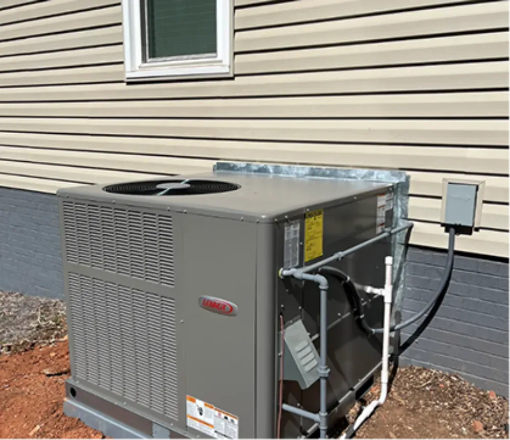 A Lennox package unit set in a mulch bed beside a Mauldin home
