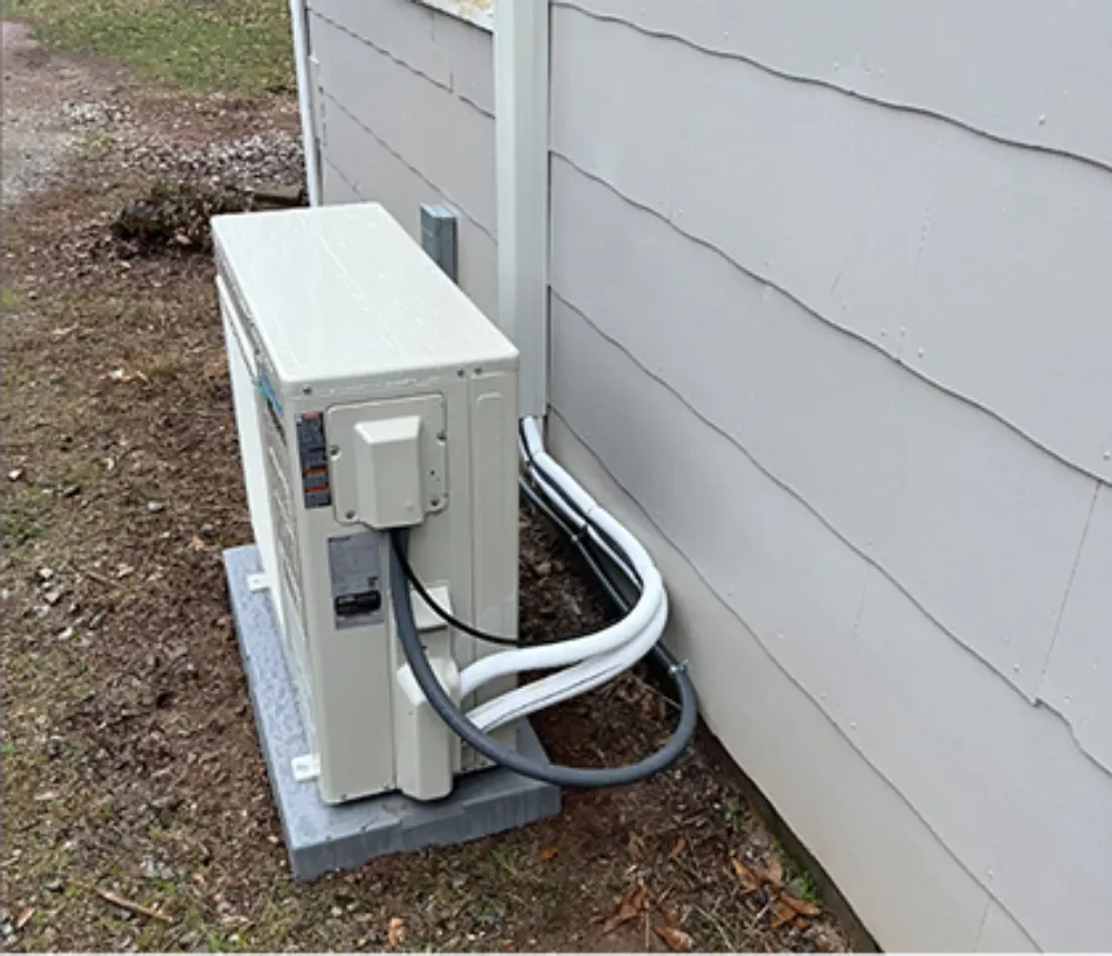 A pad mounted mini split condenser outside a Mauldin home
