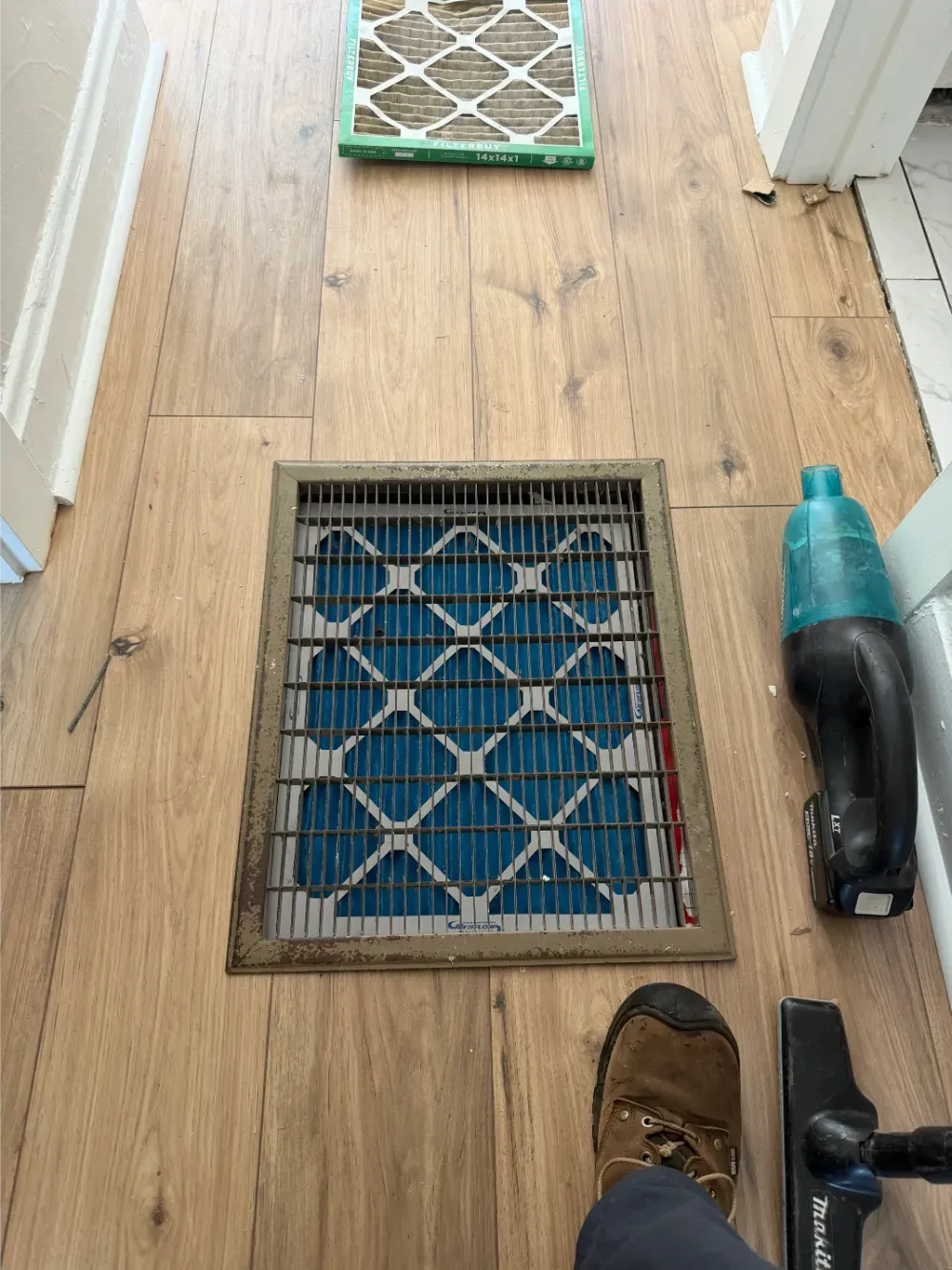 A new filter fitted behind a floor grille in an Easley home