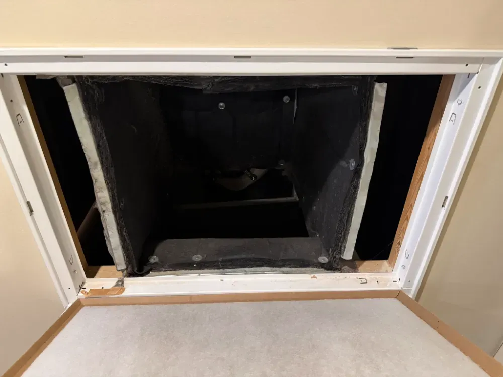 A duct boot being fitted into an open ceiling in Greenville